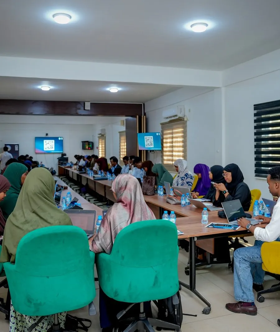 Participants learning together around a table during a training session
