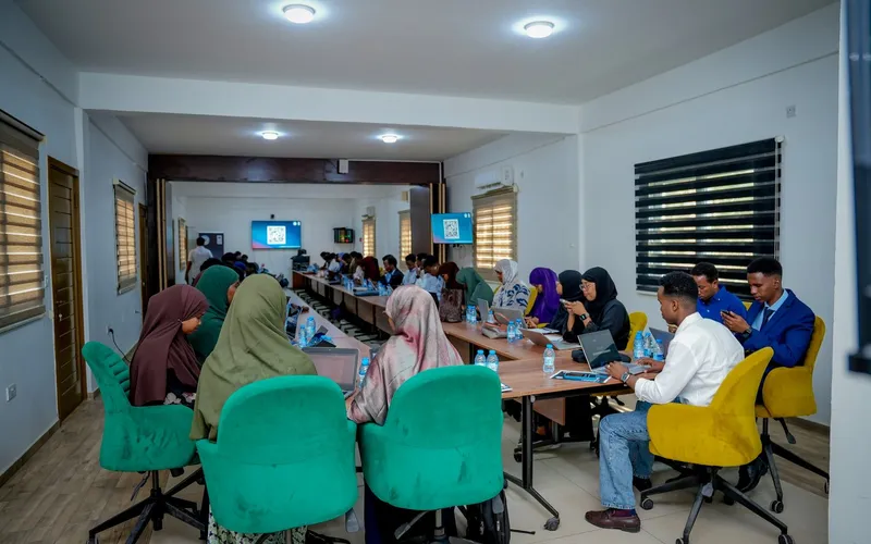 Participants learning together around a table during a training session