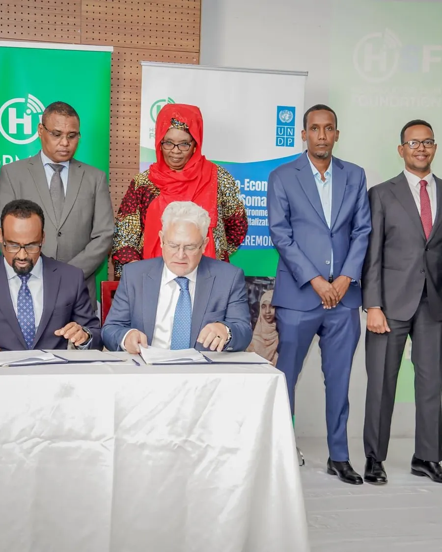 Representatives signing an agreement at a formal ceremony