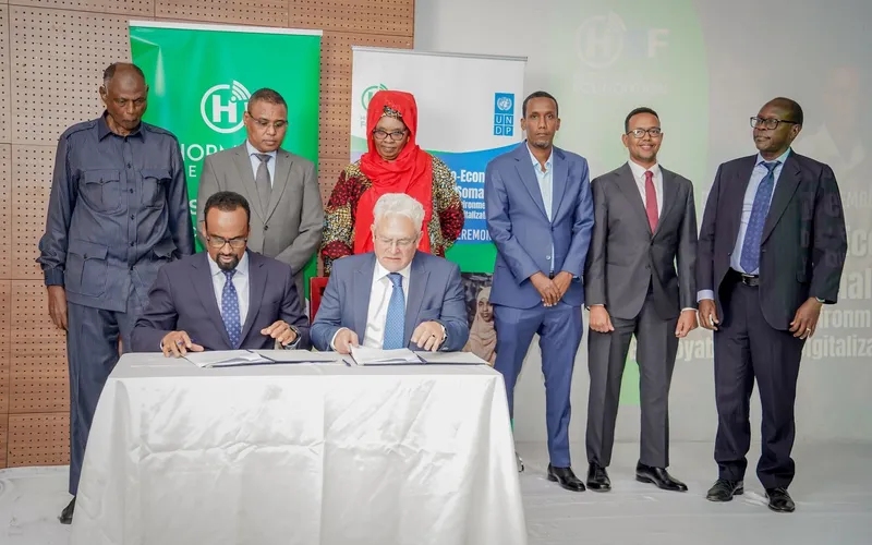 Representatives signing an agreement at a formal ceremony