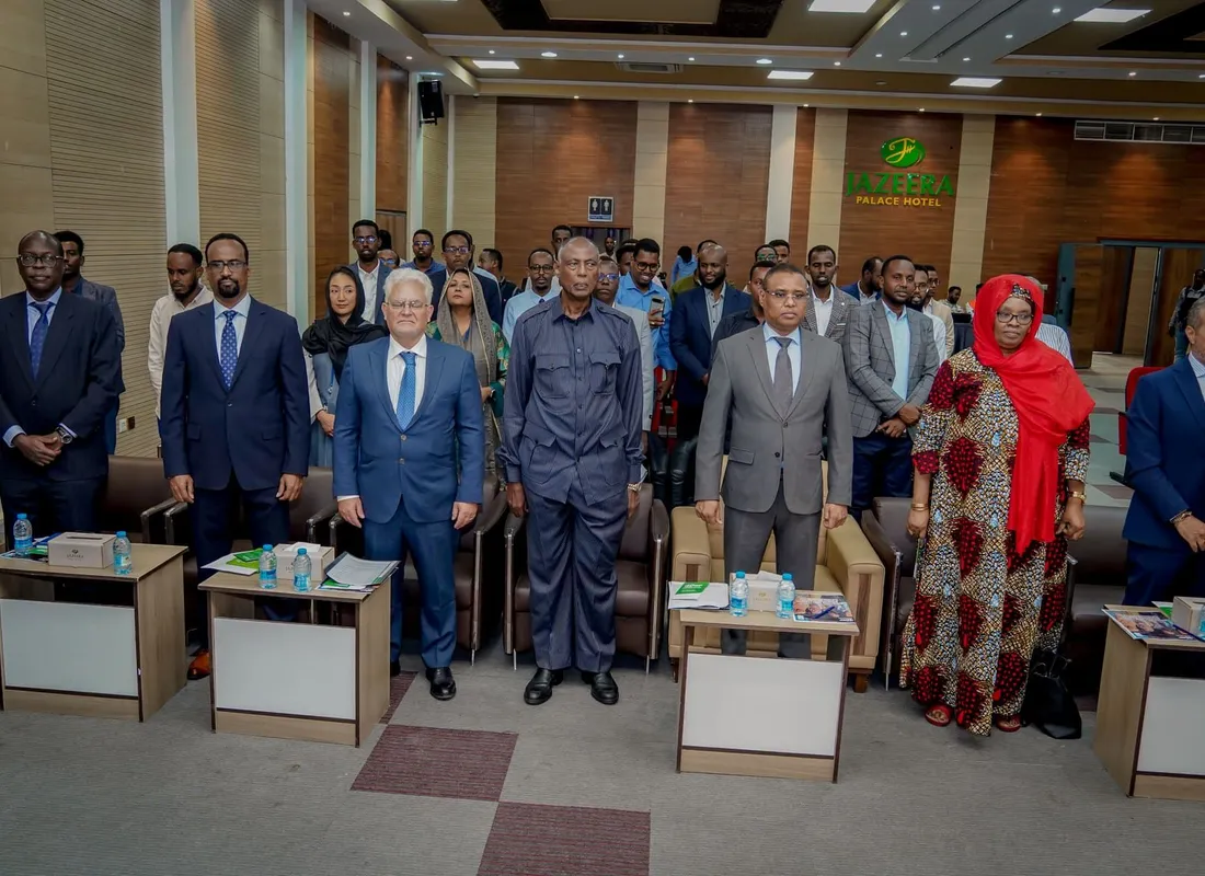 Officials and delegates standing together at a formal institutional event in Somalia