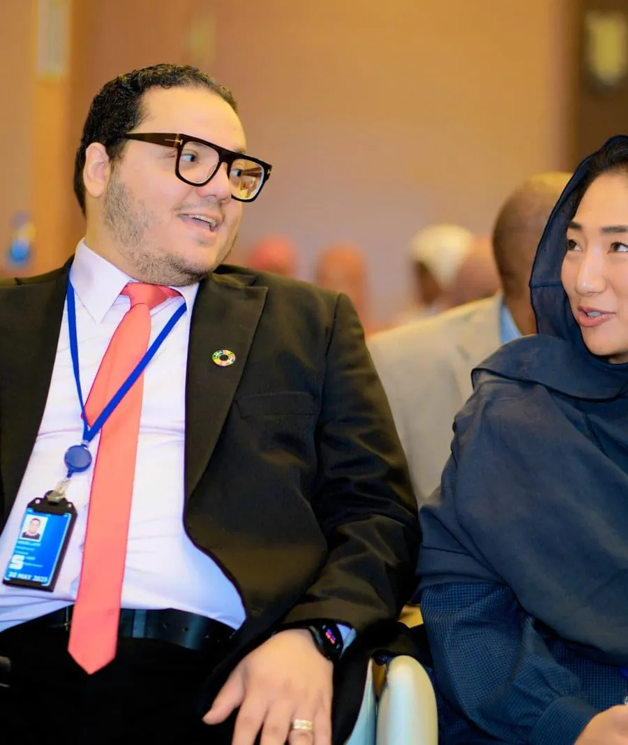 Two delegates discussing material at a data-validation workshop