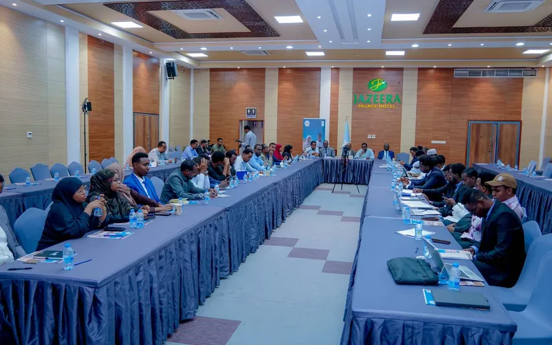 Participants gathered around a large table during a professional workshop