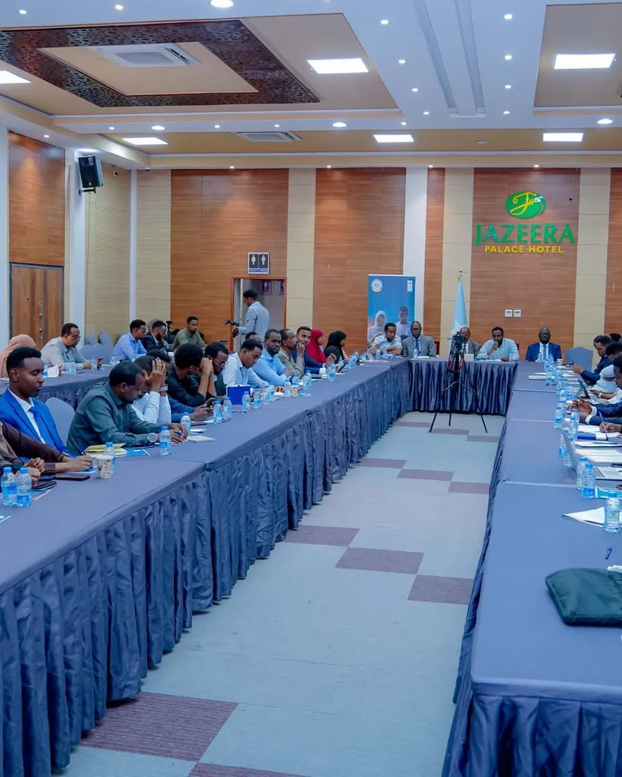 Participants gathered around a large table during a professional workshop